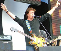 Paul McCartney performing on stage.