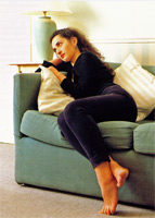 Woman leaning heavily on a sofa
